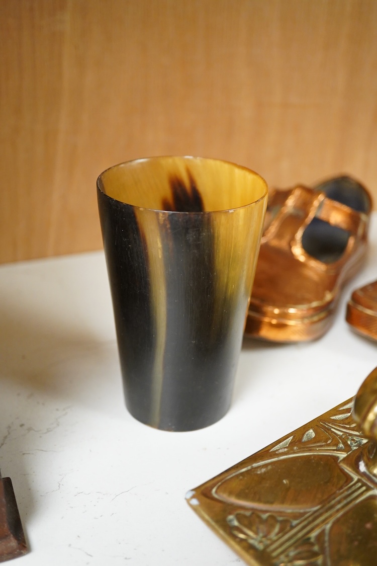 A collection of mixed metalware to include a copper plaque and brass ink blotter, together with a horn beaker